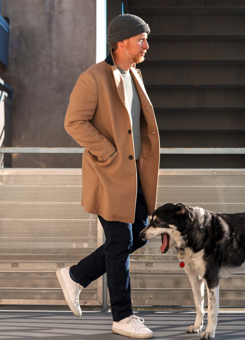 man wearing a camel topcoat as a part of a scandinavian minimalist outfit