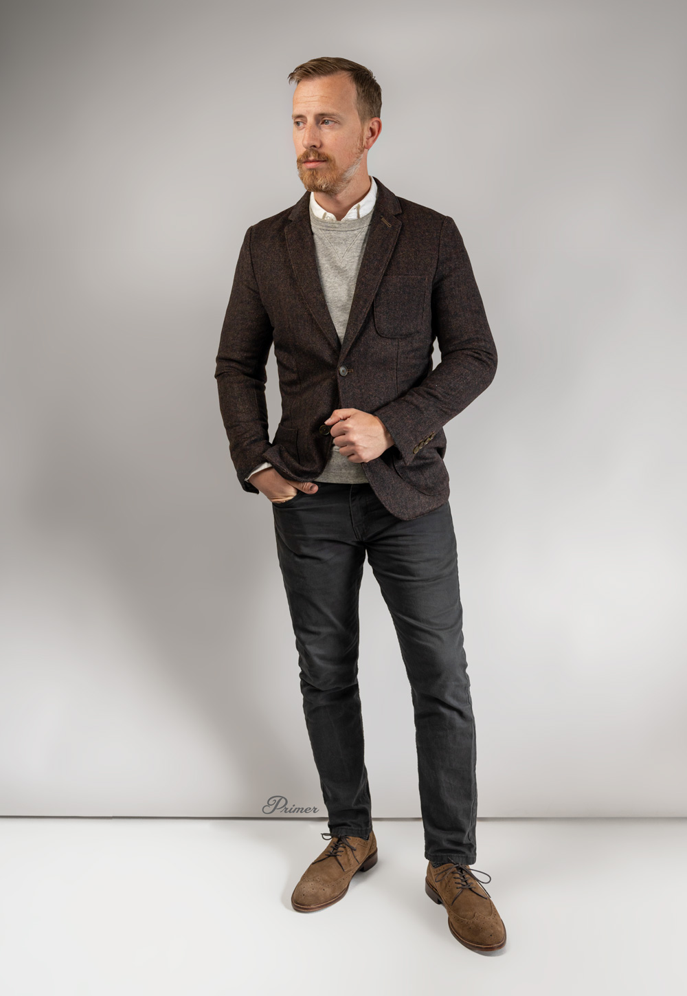 business casual outfit with brown blazer, white dress shirt, gray jeans, and suede wingtips