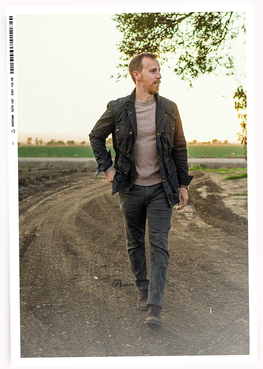 man wearing spring outfit featuring Banana Republic Traveler Jeans, field jacket and a sweater