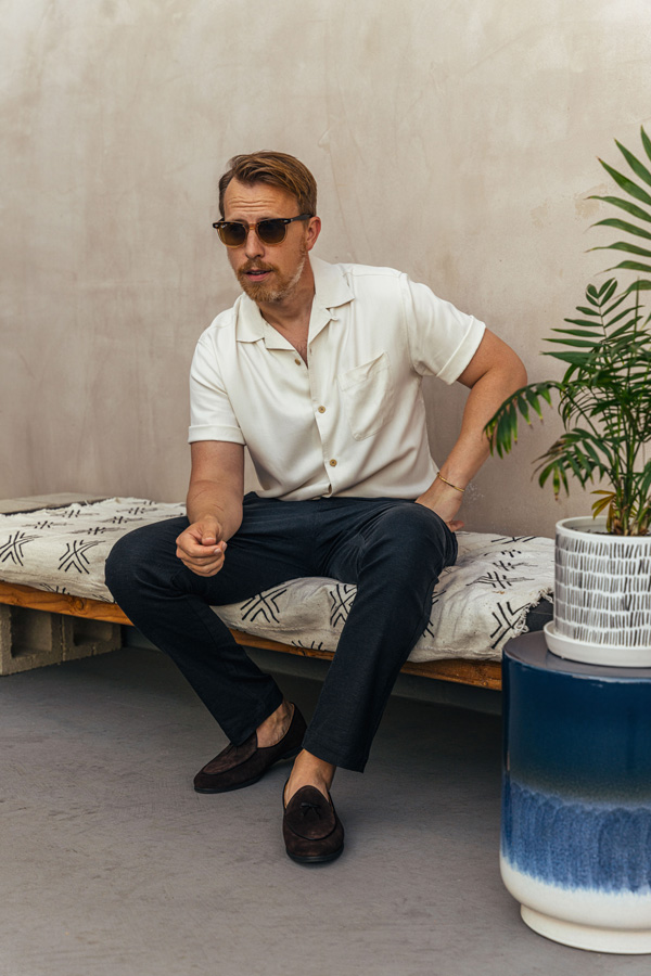 man wearing camp collar shirt with gray linen pants and brown loafers