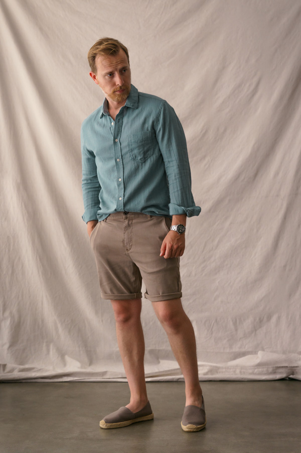 man wearing a linen shirt, shorts, and espadrille shoes