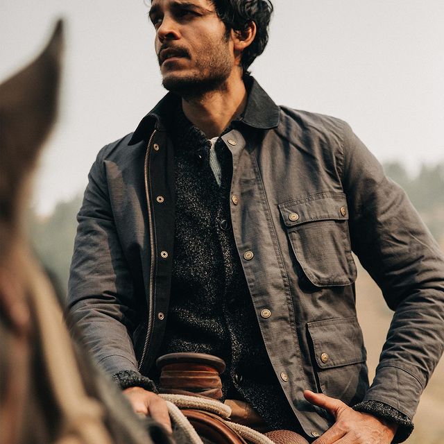 a man wearing a jacket and sweater from Taylor Stitch