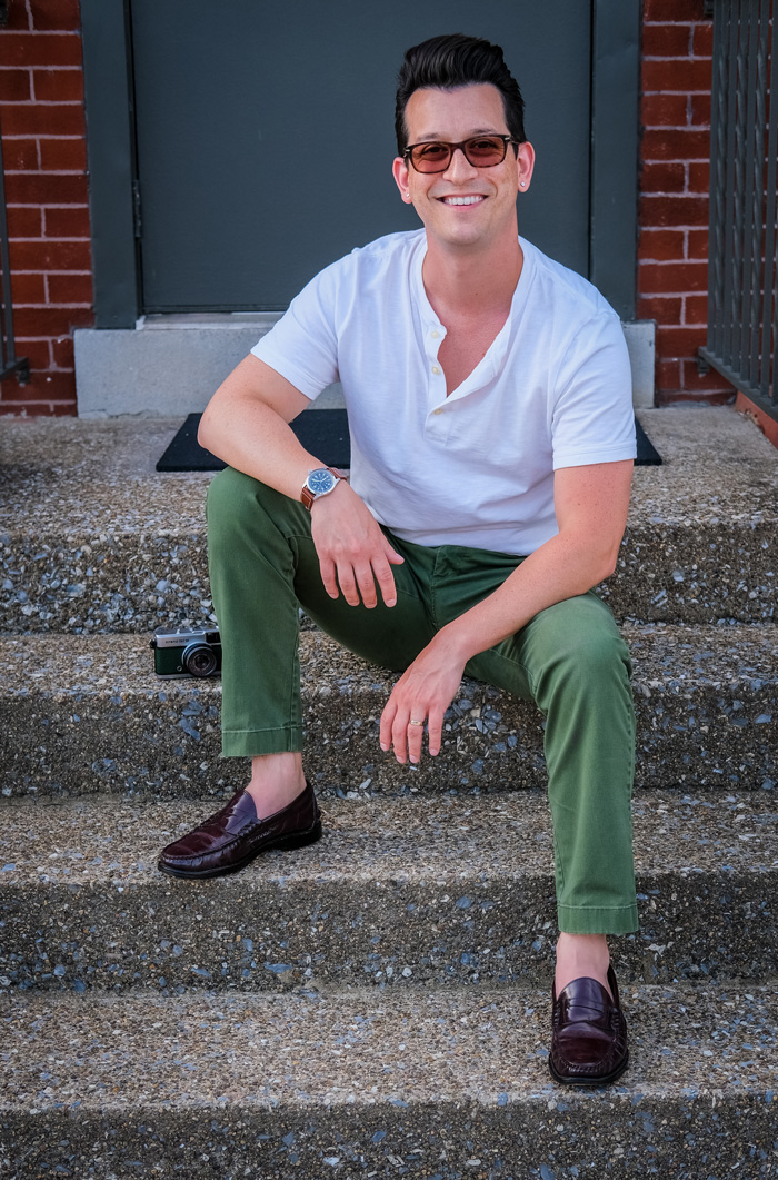 Mike Henson wearing white henley, green chinos, and brown penny loafers