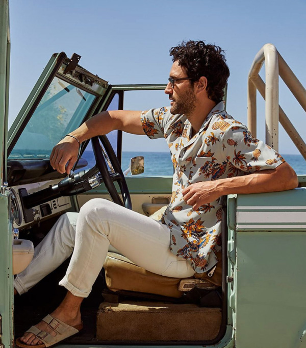 a man wearing a short sleeve printed shirt, slim pants, and sandals from Todd Snyder