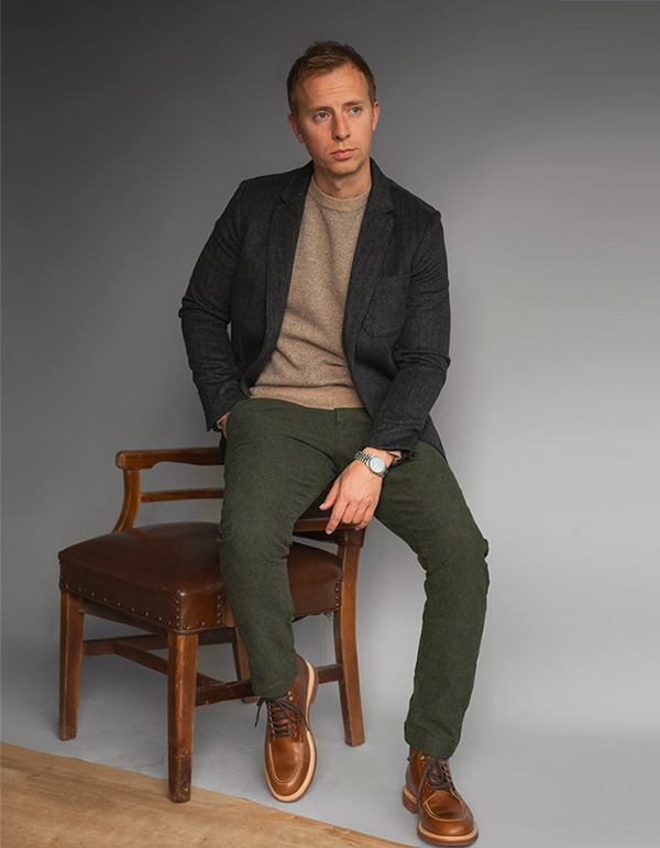 a man wearing a blazer, sweater, and pants from J.Crew