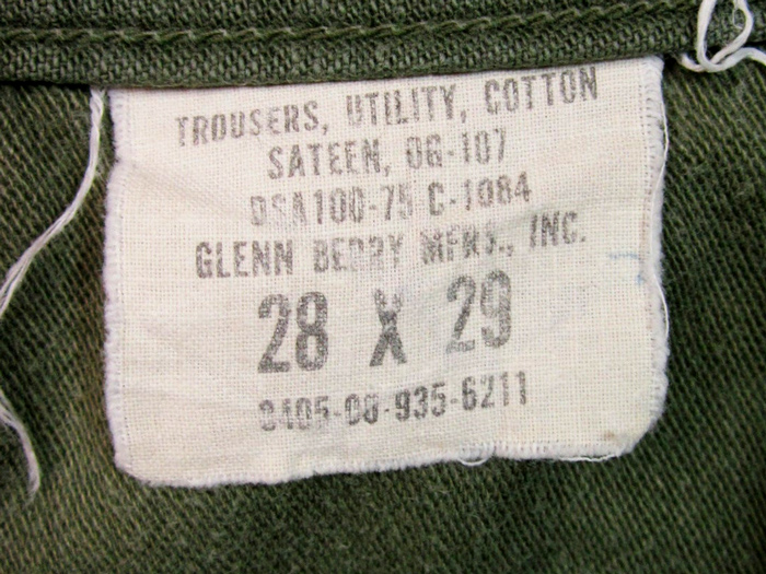 a clothing tag located inside fatigue pants listing materials and size measurments 
