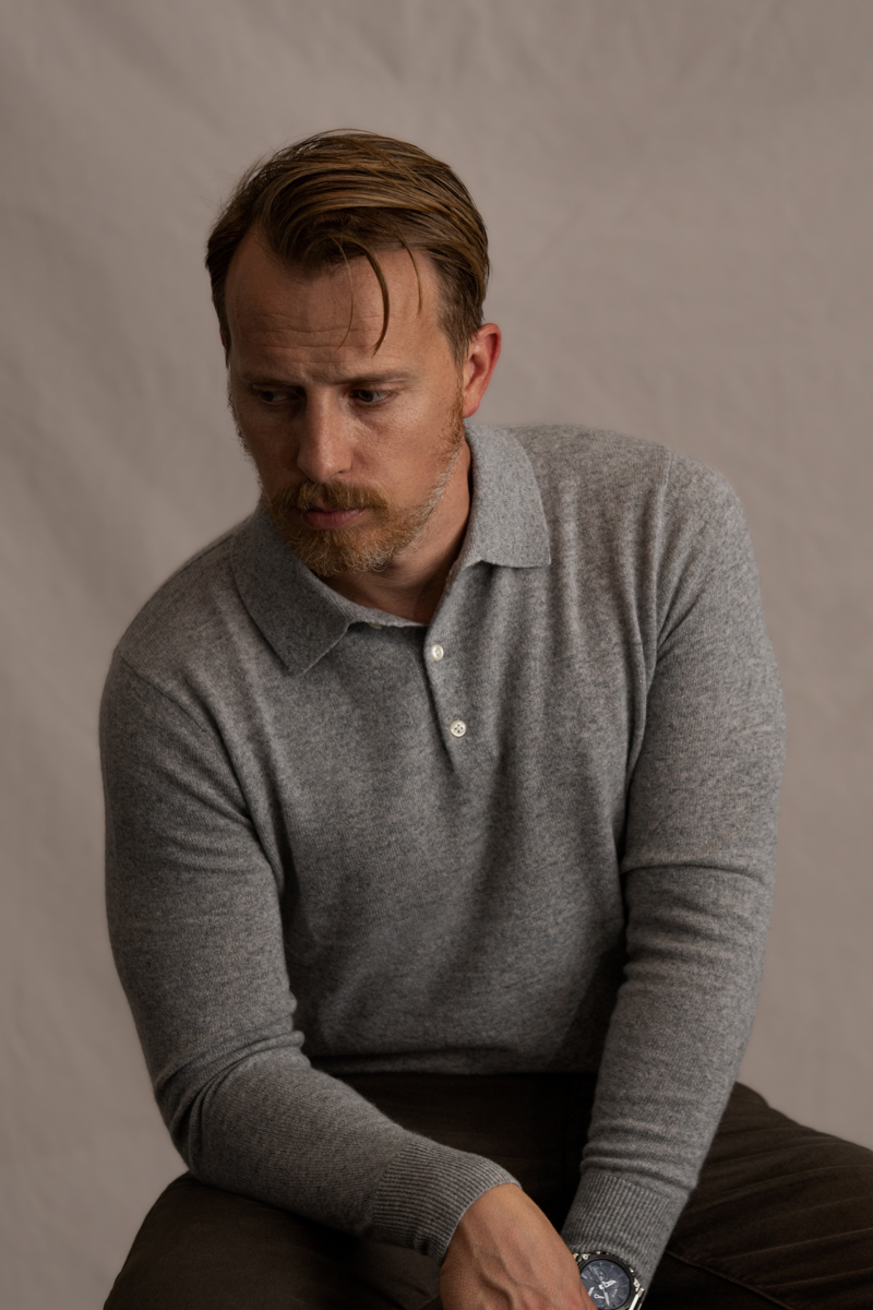 Andrew Snavely wearing a gray long sleeve knit polo