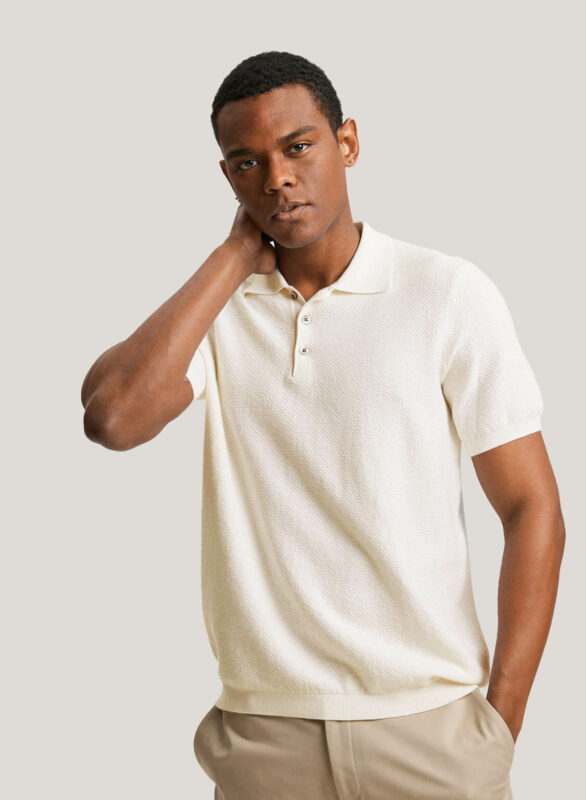 image of man wearing a white cashmere knit polo shirt with short sleeves