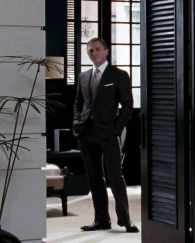 daniel craig james bond wearing a brown suit and tie