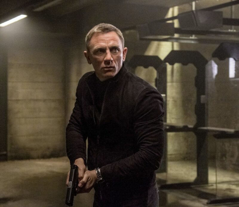 daniel craig james bond wearing a suede racer jacket