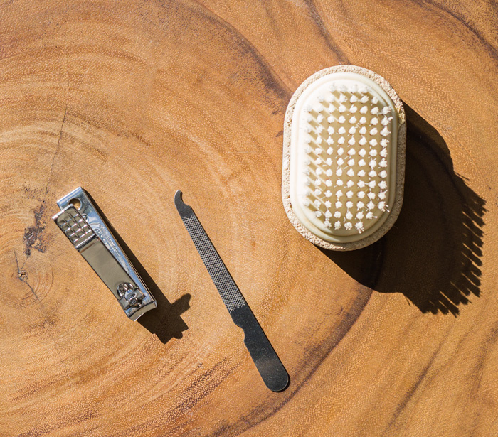 grooming items including a nail brush, a nail clipper, and a nail file