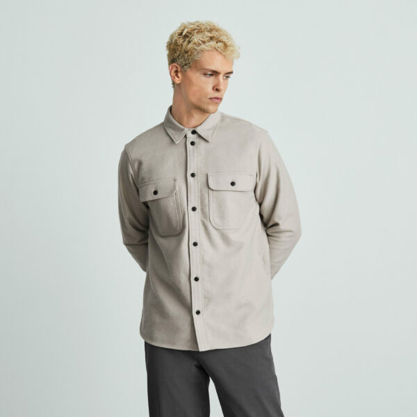 image of a man wearing a long sleeve gray button down shirt