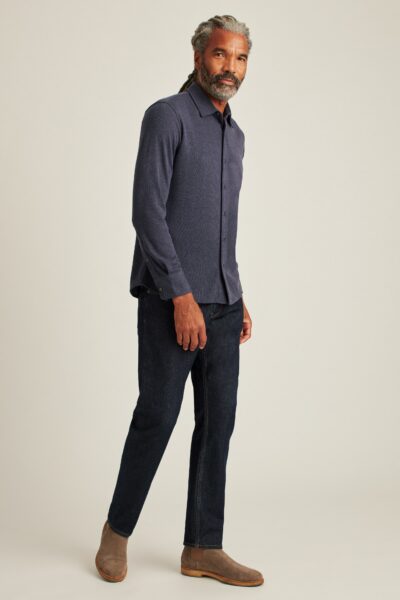 image of a man wearing a navy blue long sleeve shirt and black pants