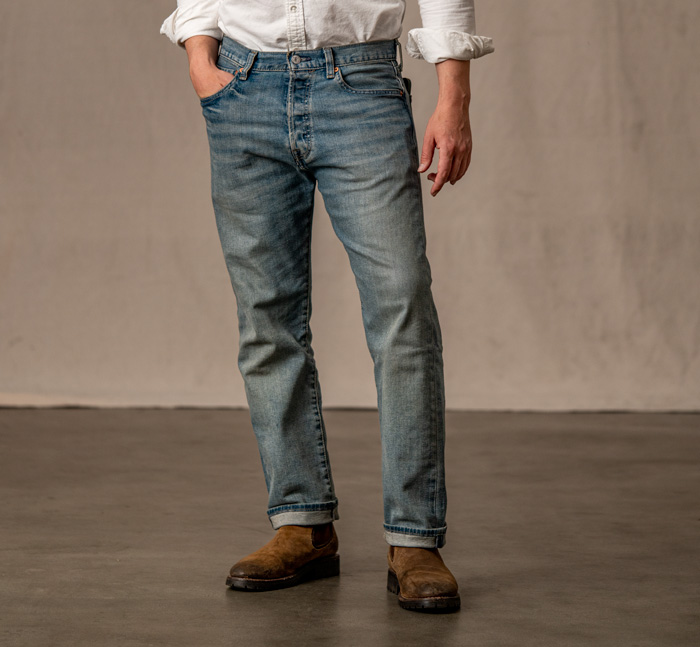 A pair of levi's 501 light wash jeans with cuffed legs