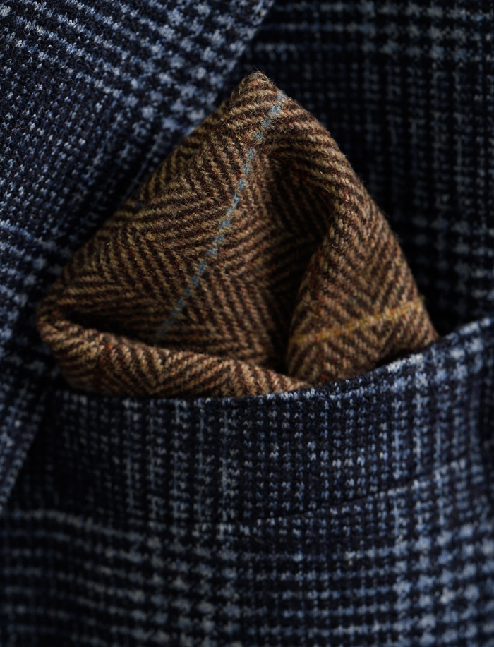 brown plaid pocket square in blue sport coat pocket