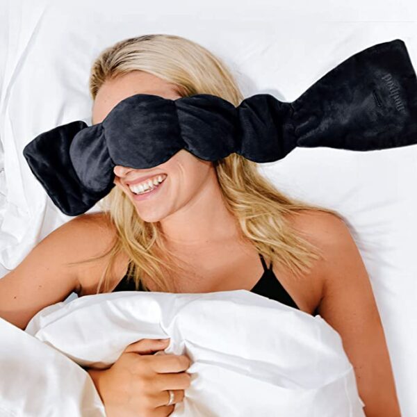 image of a woman wearing a black sleep eye mask