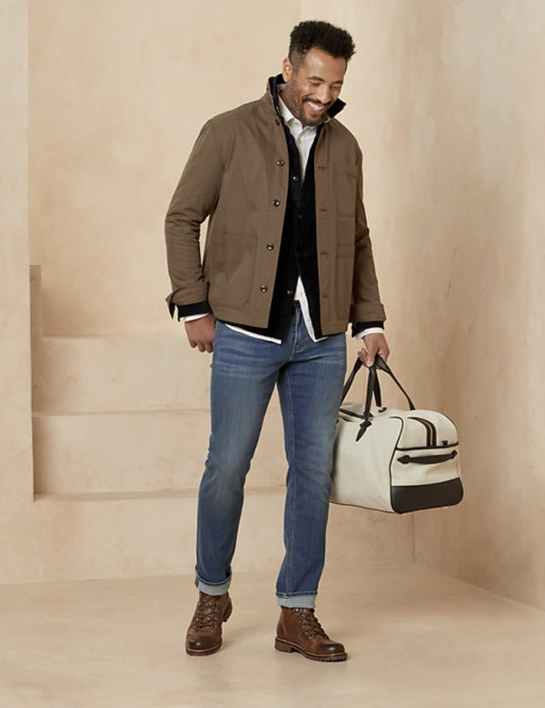 image of a man wearing a brown jacket and blue jeans