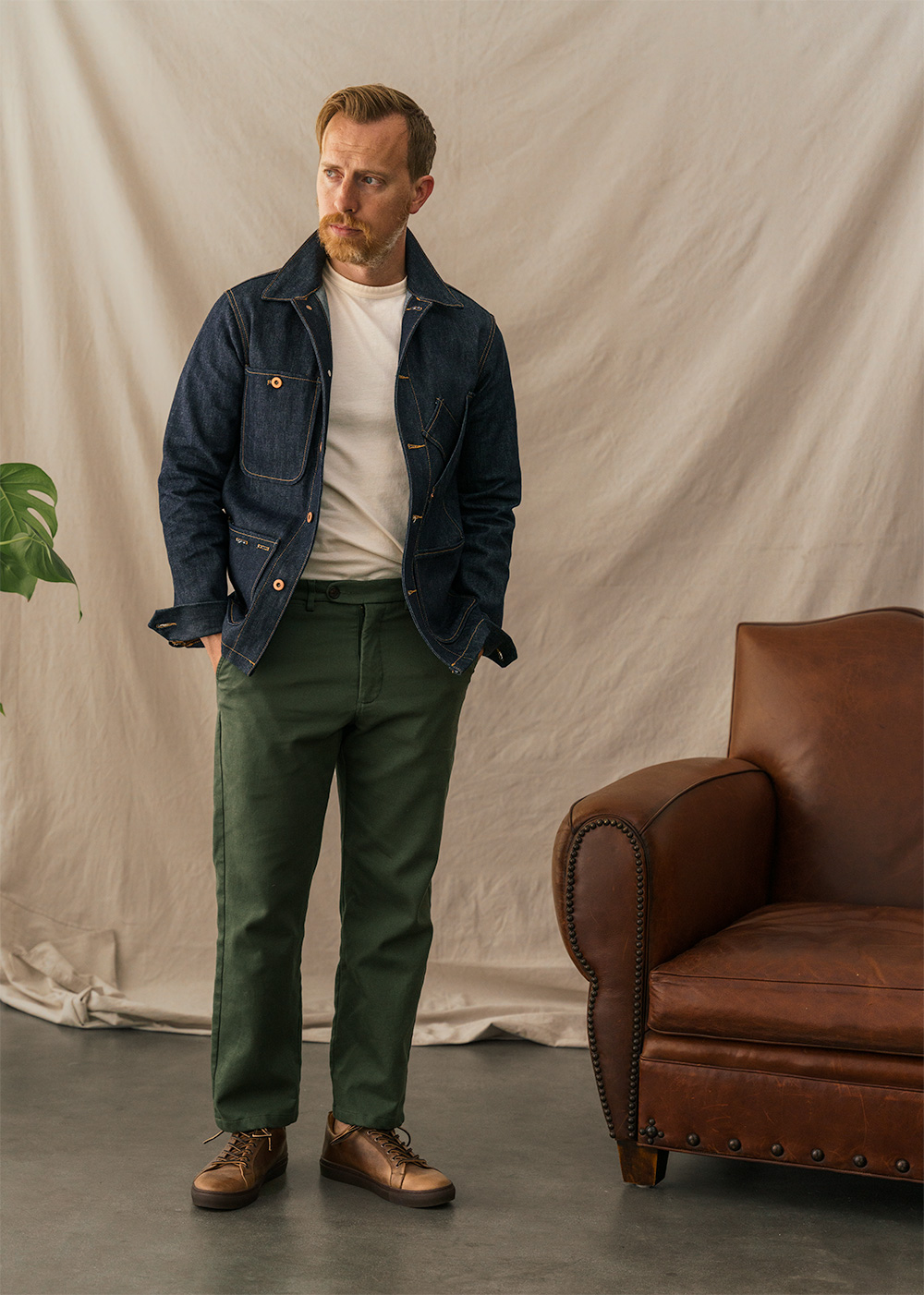 men's outfit with full cut trousers with sneakers and chore coat