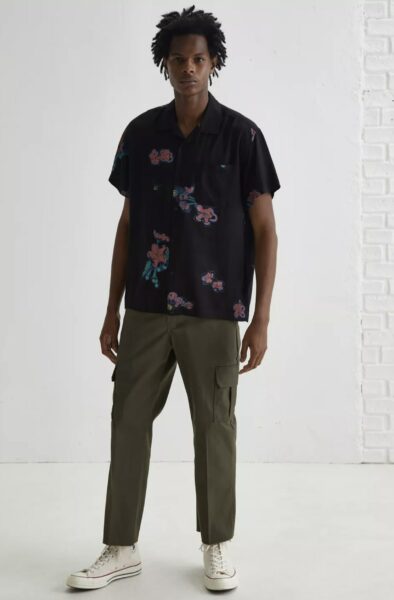 image of a man wearing a printed shirt and utility style pants
