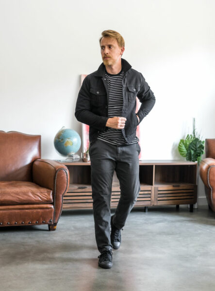 image of a man wearing chino pants and black jacket