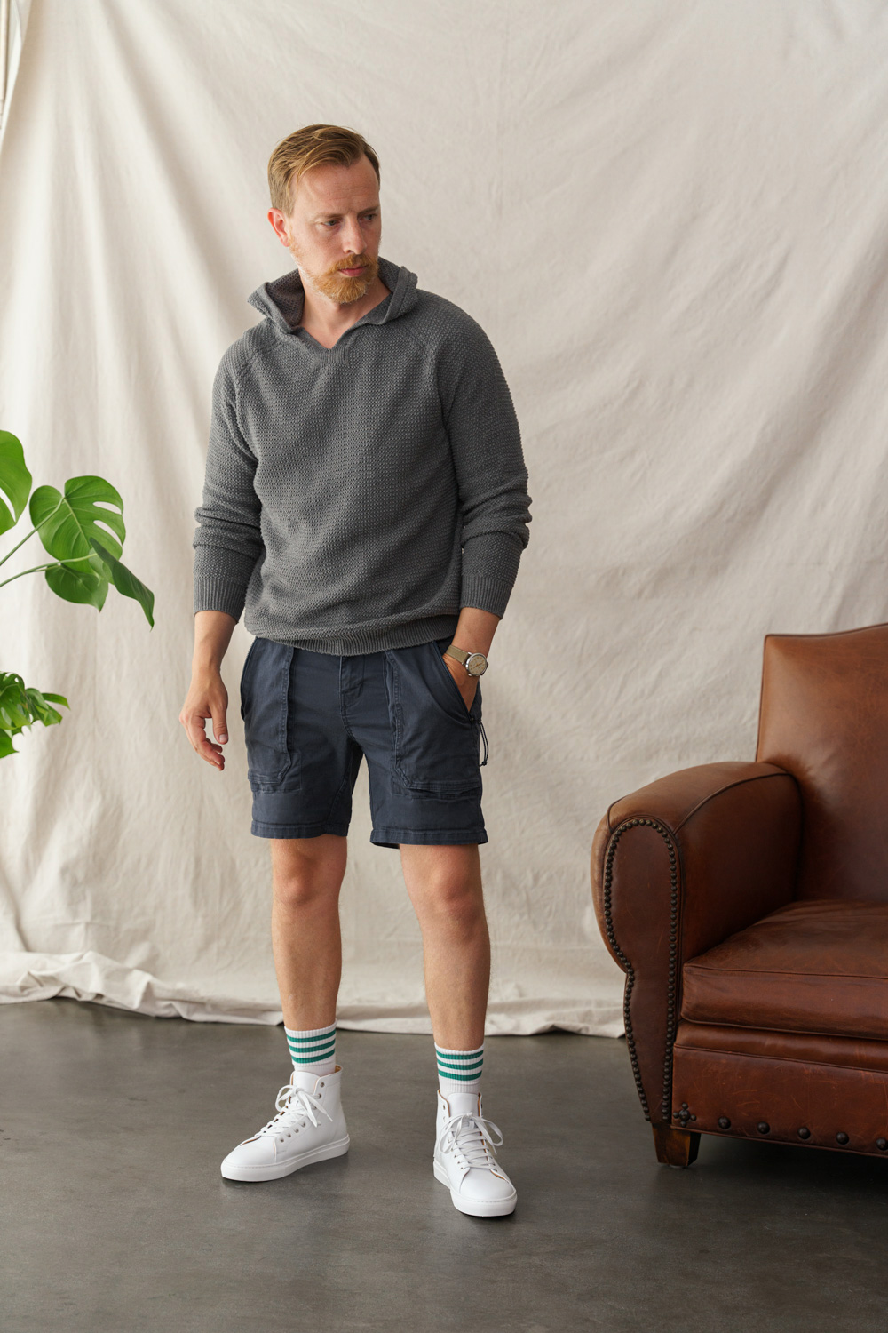 summer outfit with high top sneakers blue shorts and hoodie sweatshirt