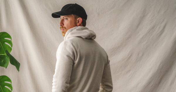 man wearing black hat and white hoodie