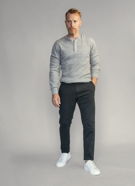 image of a man wearing a grey shirt and black pants