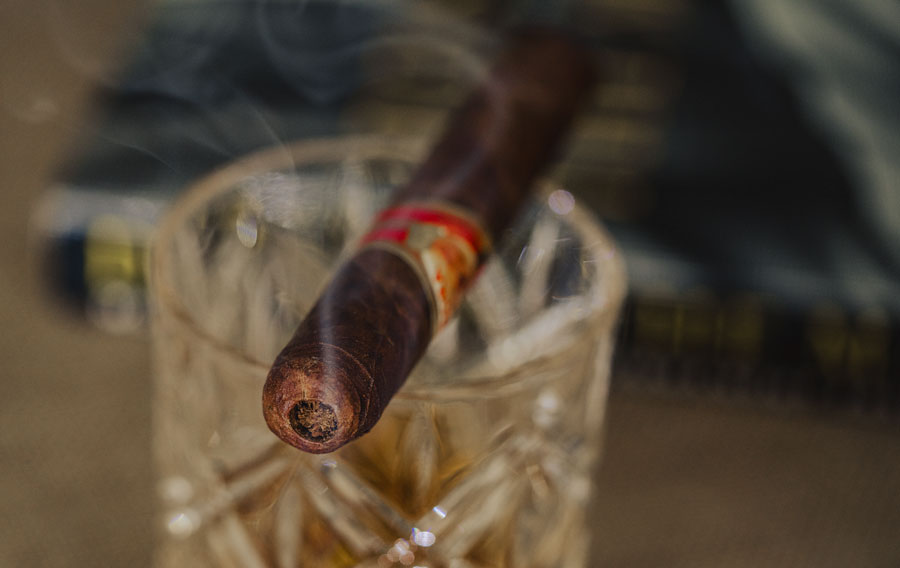 cigar sitting on a glass