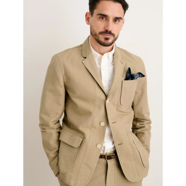 image of a man wearing a tan color blazer