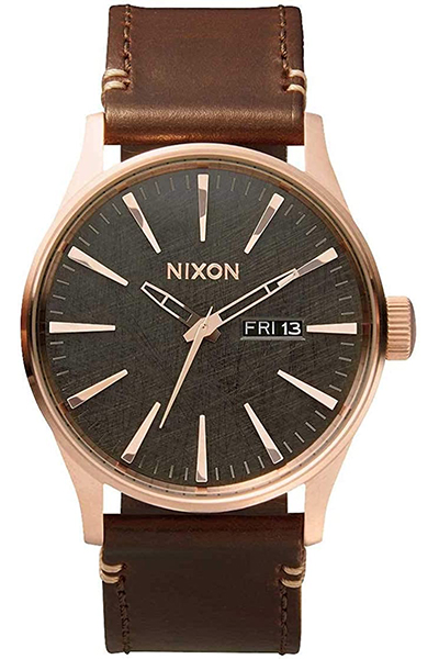 image of a watch with rose gold details and leather strap
