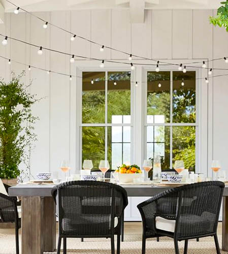image of an outdoor patio dining set and string lights hanging