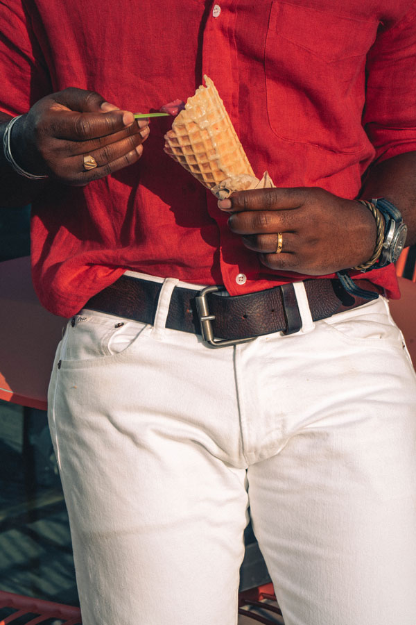 white jeans with red shirt and brown belt