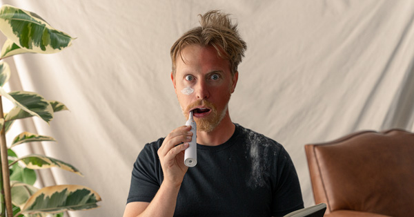 a man using an electric toothbrush 