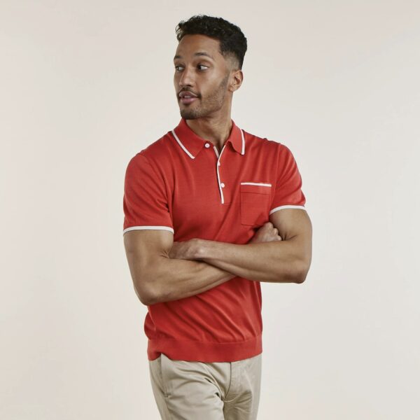 image of a man wearing a coral red short sleeve polo shirt