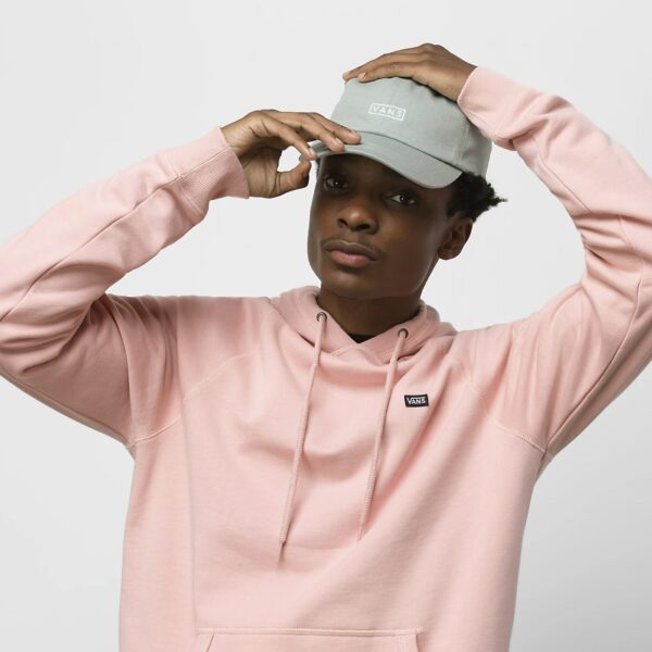 image of a man wearing a pink hoodie sweatshirt and a gray ball cap