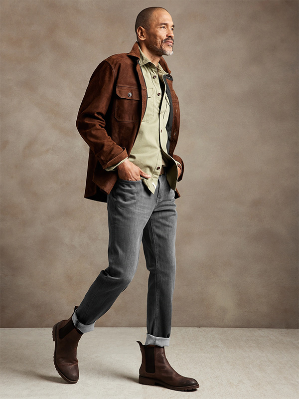 image of a man wearing a brown jacket and black denim jeans