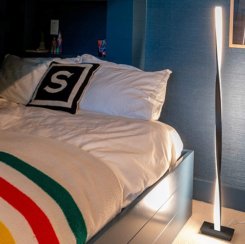 helix LED floor lamp beside a bed