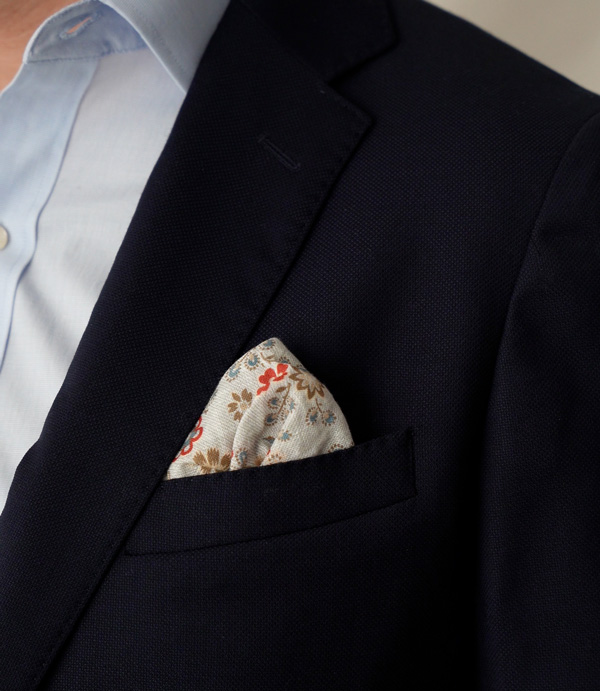 floral pocket square in a navy jacket chest pocket