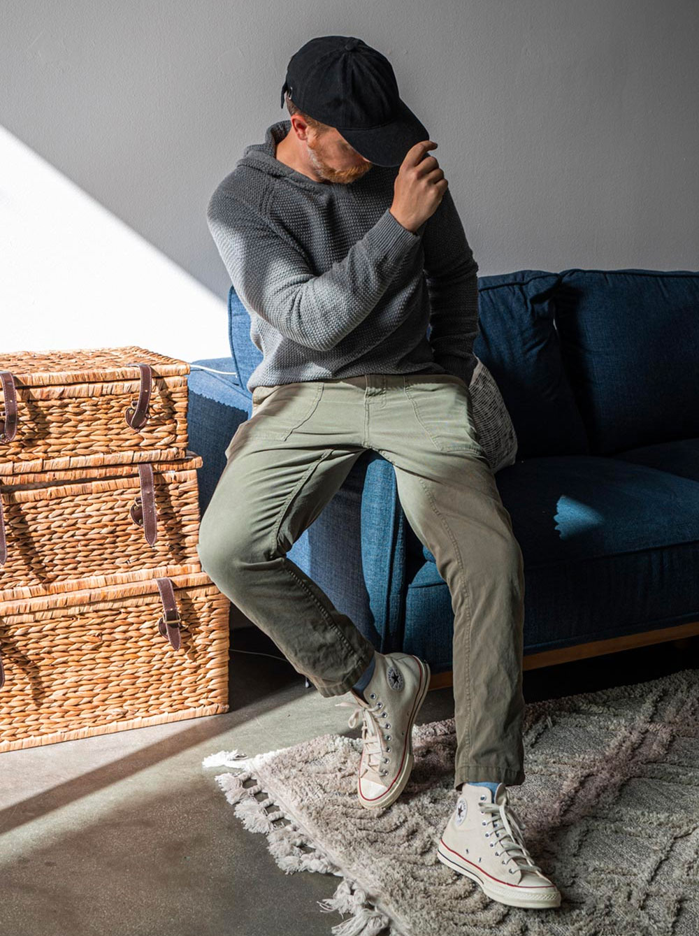 man wearing casual dress code with a grey knit hoodie and green pants