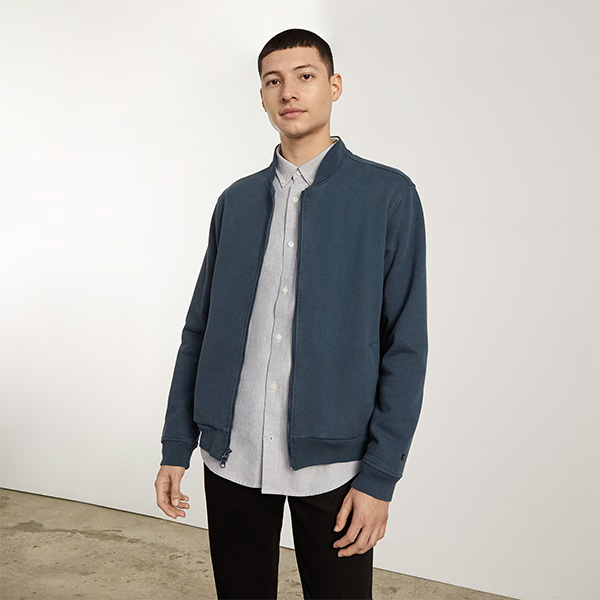 image of a man wearing a blue bomber style jacket
