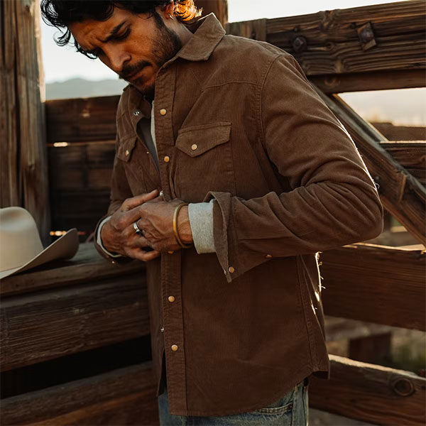 a man wearing a corduroy snap button long sleeve shirt