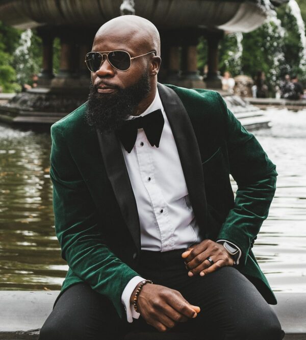 image of a man wearing a green suit jacket and black bow tie