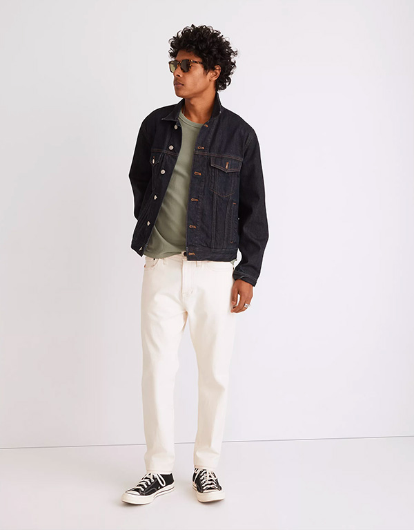 image of a man wearing a denim jacket and white pants