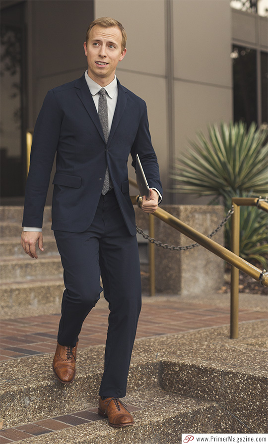  man wearing professional dress code - navy suit with tie