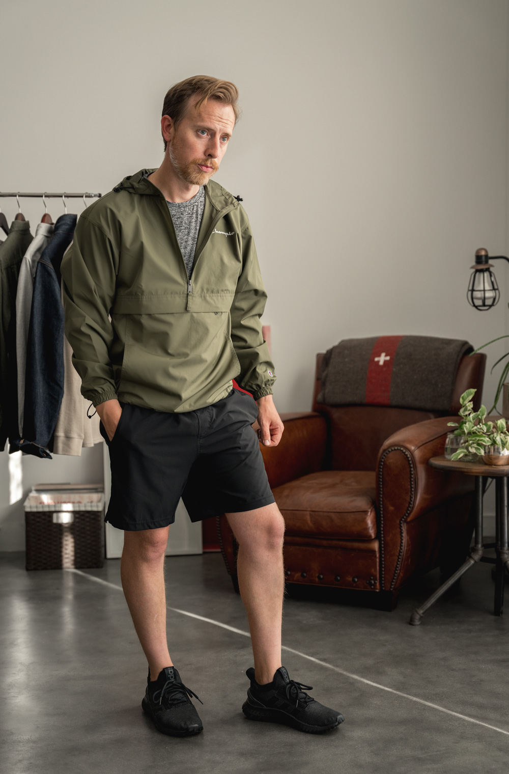 Modern sportswear with a green blazer, gray performance shirt, black track shorts and black Adidas trainers