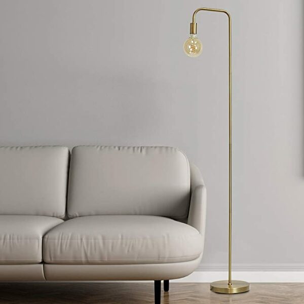 a gold metal floor lamp and grey couch in a living area