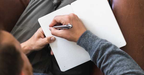 a person writing in a journal