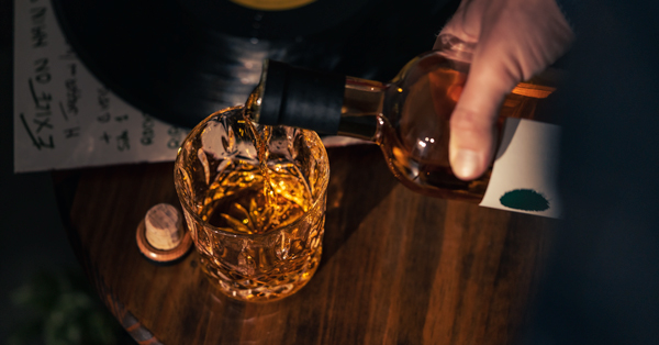 a bottle of irish whiskey being poured into a glass