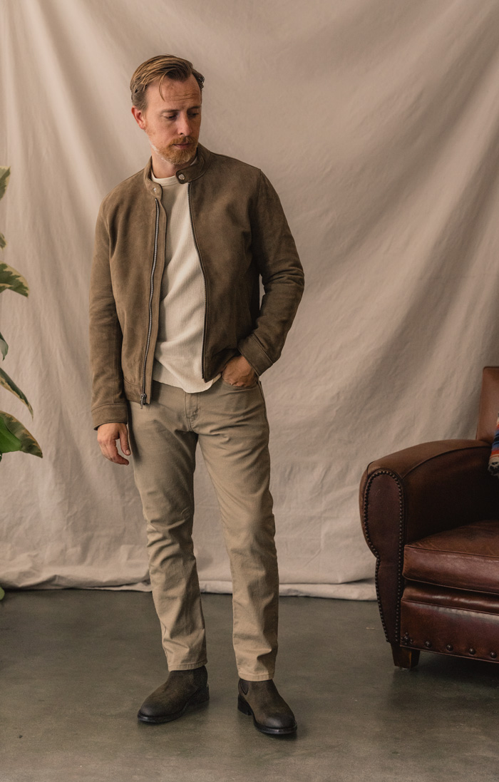 outfit made of shades of tan with taupe suede jacket, cream thermal, khaki jeans, and olive suede chelseas