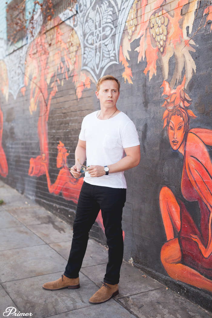 a men's outfit with black jeans, brown chukka boots and a white tshirt